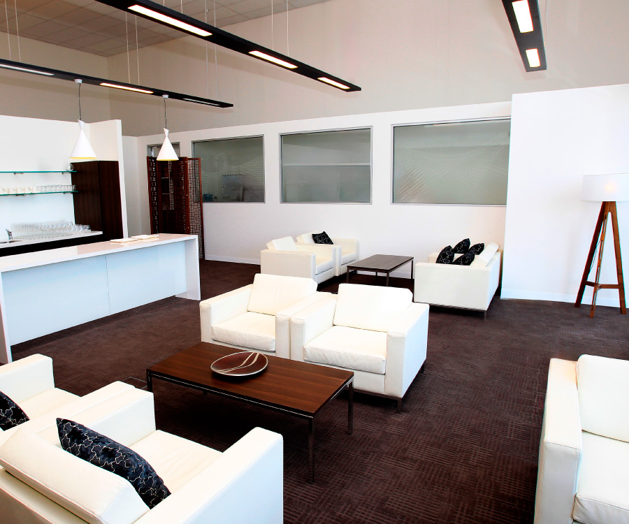 Our elegant ExecuJet Sydney FBO lounge featuring plush beige couches and tastefully decorated interiors.